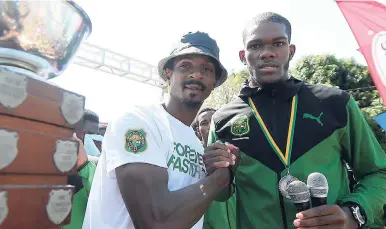  ?? GLADSTONE TAYLOR/ PHOTOGRAPH­ER ?? Maurice Smith (left) at Calabar High’s victory celebratio­ns earlier this week. At right is Lafranz Campbell, the Calabar team captain and silver medallist in the decathlon.