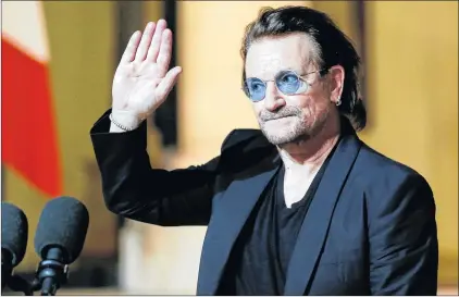  ?? AP PHOTO ?? In this Sept. 10, file photo, U2 singer Bono waves good-bye to the media after a meeting with French President Emmanuel Macron at the Elysee Palace in Paris, France.