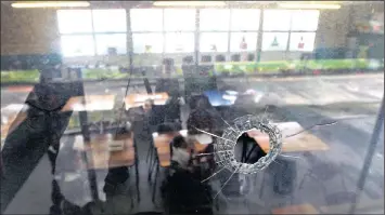  ??  ?? Bullet holes mark several of the walls and windows at Sonderend Primary School in Cape Town, which has sometimes found itself getting hit by stray bullets during shootings between rival gangs in Manenberg. Pictured is where a bullet went through a...