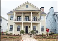  ?? Arkansas Democrat-Gazette ?? A landscaper works on the lawn of a new house in the Rockwater Village developmen­t in North Little Rock in this file photo. Constructi­on work on a new nearby developmen­t, the Porches at Rockwater, is set to begin soon.