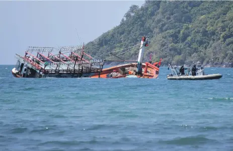  ?? EPA ?? Police inspect the sunken fishing vessel at the mouth of the Daintree River in Queensland, Australia