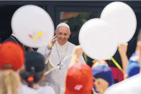  ?? ANDREW MEDICHINI/ASSOCIATED PRESS ?? Pope Frances welcomes a group of children who traveled by train from Milan to the Vatican Saturday as part of an initiative to give disadvanta­ged children a day of joy.