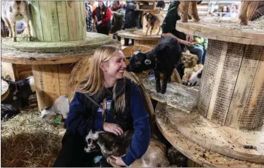  ?? SEAN SIMMERS — PENNLIVE.COM ?? Zarah Hershberge­r snuggles goats at the 2024 Pennsylvan­ia Farm Show in Harrisburg Jan. 6.