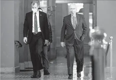  ?? TASOS KATOPODIS/GETTY ?? Senate Majority Leader Mitch McConnell, R-Ky., right, walks to the Senate floor last week at the U.S. Capitol.