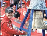  ?? Alex Gallardo / The Associated Press ?? Kyle Larson rings the El Camino Real bell after his win in Sunday’s race at Auto Club Speedway in Fontana, Calif.