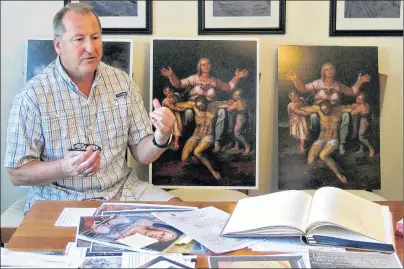  ?? THE ASSOCIATED PRESS ?? Martin Kober displays literature and copies of a family heirloom that he believes was painted by Renaissanc­e master Michelange­lo, at his home in Tonawanda, N.Y. Kober is convinced the painting of a dying Jesus that hung above the mantel in his upstate...