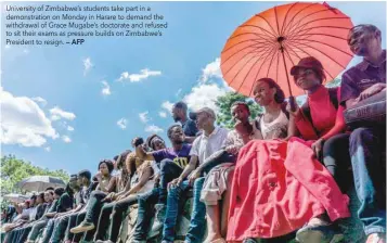  ?? — AFP ?? University of Zimbabwe’s students take part in a demonstrat­ion on Monday in Harare to demand the withdrawal of Grace Mugabe’s doctorate and refused to sit their exams as pressure builds on Zimbabwe’s President to resign.