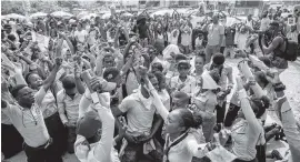  ?? DIEU NALIO CHERY AP ?? Students in their school uniforms kneel chanting anti-government slogans during protest march Thursday in Port-au-Prince.