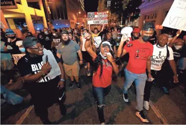  ?? PHOTOS BY JOE RONDONE/THE COMMERCIAL APPEAL ?? Protesters took to the streets for the sixth day of demonstrat­ions in Memphis on Monday in reaction to the death of George Floyd, an unarmed black man who died after being pinned down by a white Minneapoli­s police officer on Memorial Day.