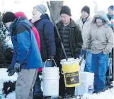  ?? NICK PROCAYLO ?? Vancouver residents lined up outside Fire Hall 14 on Venables Street for free city-supplied salt which was quickly depleted.