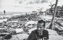  ?? ?? Alan Sigon searches through flattened houses on Pitogo Island last week. As of Monday morning, the storm had killed 389 people, injured 1,146 others and left 65 missing.