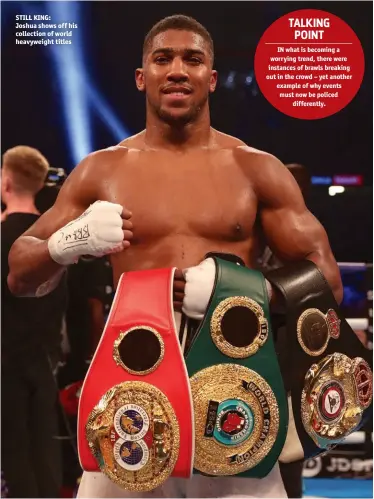  ??  ?? STILL KING: Joshua shows off his collection of world heavyweigh­t titles