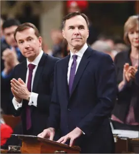  ?? The Canadian Press ?? Liberal MPs applaud Finance Minister Bill Morneau after he delivers the federal budget in the House of Commons on Tuesday.