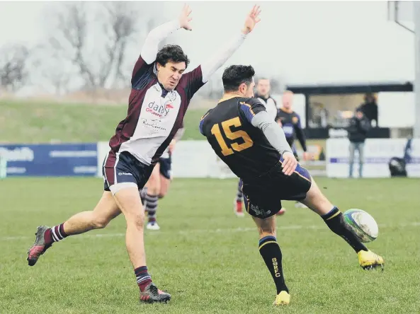  ??  ?? Scarboroug­h’s Tom Harrison charges down the Bradford Salem number 15 during the home side’s 15-13 win at Silver Royd Pictures by Andy Standing