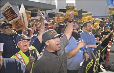  ?? Damian Dovarganes Associated Press ?? UPS WORKERS rally for a new contract in L.A. last week. A 10-day strike could have cost the U.S. economy more than $7 billion.