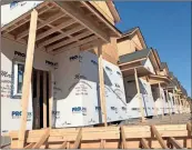  ?? John Bailey ?? Ten new townhomes, marketed as Riverbend Off Broad, are one of several new home sites under constructi­on. The ones currently being built will likely be joined by more on East Third Street.