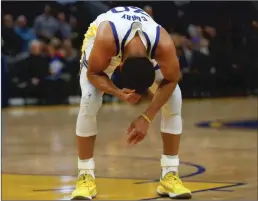  ?? Bay Area News Group/tns ?? Golden State Warriors’ Stephen Curry reacts after injuring his hand against the Phoenix Suns.