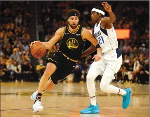  ?? NHAT V. MEYER/BAY AREA NEWS GROUP ?? The Warriors' Klay Thompson (11) dribbles against the Mavericks' Frank Ntilikina (21) during their NBA Western Conference Finals playoff game in San Francisco on Wednesday.