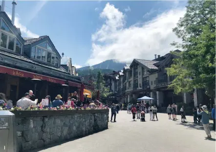  ??  ?? 1 The village dining and shopping with the majestic whistler as backdrop
1