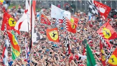  ?? LUCA BRUNO THE ASSOCIATED PRESS ?? Ferrari fans celebrate in a sea of red after Charles Leclerc won the Italian Grand Prix, the team’s first at Monza since 2010.