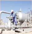  ??  ?? A worker inspects a pipe at Nahr Bin Umar oil field, north of Basra, Iraq.