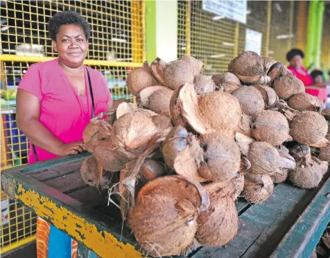  ?? . Photo: Laiseana Nasiga ?? Amelia Kainavatu selling coconuts at the Suva Municipal Market