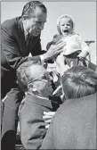  ?? HARVEY GEORGES/AP PHOTO ?? A law and order strategy proved successful for Republican presidenti­al candidate Richard M. Nixon, shown on the trail in 1968 as he tries to comfort a crying infant on Long Island, N.Y., Oct. 5, 1968. Nixon defeated Hubert Humphrey.