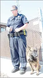  ?? Keith Bryant/The Weekly Vista ?? Officer Travis Trammell, left, stands with the Bella Vista Police Department’s new K9 unit, Cabo.