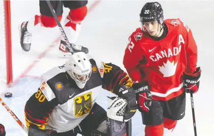  ?? CODIE MCLACHLAN/ GETTY IMAGES ?? Dylan Cozens, right, has been a pain in the side of opposing goalies, including Germany's Jonas Gahr.