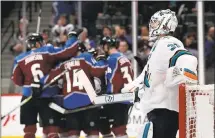  ?? JOE MAHONEY — ASSOCIATED PRESS ?? Sharks goalie Martin Jones leans on the goal as the Colorado Avalanche celebrates Carl Soderberg’s goal in the first period.