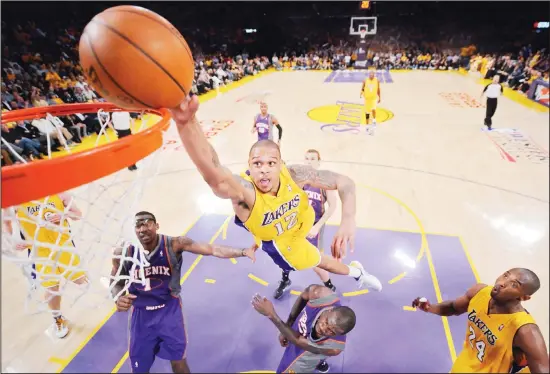  ??  ?? In this May 17, 2010 file photo, Los Angeles Lakers guard Shannon Brown, (center top), attempts a dunk as Phoenix Suns forward Amare Stoudemire, (left), and guard Jason Richardson, (center bottom), defend while Lakers guard Kobe Bryant, (right), watches during the second half of Game 1 of the NBA basketball Western Conference finals in Los Angeles. Former
NBA player Brown faces charges in suburban Atlanta after he was accused of firing a rifle at two people who were looking at homes for sale, police said. Brown, 34, was arrested on a charge of aggravated assault stemming from an incident May 2, 2020, at his home in Tyrone, Georgia. He is free after he posted bond on May 4. (AP)