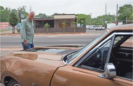  ?? ALICIA DEVINE/TALLAHASSE­E DEMOCRAT ?? Jeff Leckinger looks over the 1969 Oldsmobile F-85 Cutlass W-31 that he bought 55 years ago during a reunion coordinate­d by the current owner, Steve Puleo, on April 1.