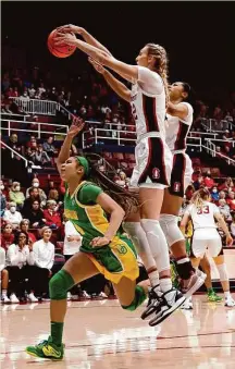  ?? Josie Lepe / Associated Press ?? Stanford forward Cameron Brink blocks a shot by Oregon guard Endyia Rogers, one of Brink’s 10 during the game.