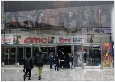  ?? (AP/Marcio Jose Sanchez) ?? People enter an AMC theater on Saturday in Los Angeles. Limited access to theaters because of the coronaviru­s pandemic should mean a spike in online video streaming services, analysts say.