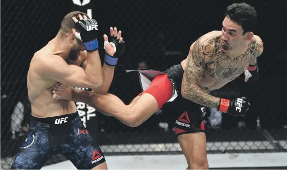  ?? UFC ?? Max Holloway, right, beat Calvin Kattar by a unanimous decision during their featherwei­ght bout at the newly-built Etihad Arena