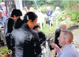  ??  ?? ●●Ann Morley and Ken Boardman with other guests at the barbecue for St Michael’s Church, Bamford