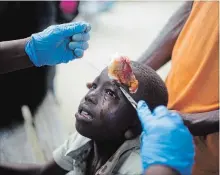  ?? DIEU NALIO CHERY THE ASSOCIATED PRESS ?? A boy injured by an aftershock receives treatment at the hospital in Port-de-Paix. The aftershock struck on Sunday, even as survivors of the previous day’s quake were sifting through the rubble of their homes.