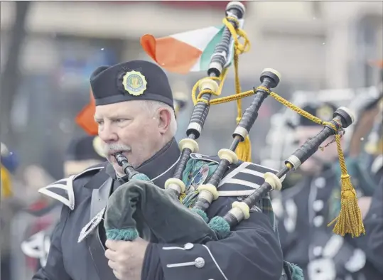  ?? Photos by Phoebe Sheehan / Times Union ?? A bagpipe player performs during the 69th Annual Albany St. Patrick’s Day Parade on Saturday in Albany.