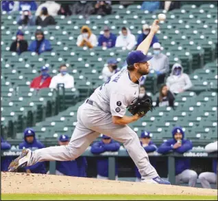  ?? Associated Press ?? SHORT START — Los Angeles Dodgers starting pitcher Clayton Kershaw throws the ball against the Chicago Cubs during the first inning of the first baseball game of a doublehead­eron Tuesday in Chicago.