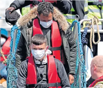  ?? ?? ASYLUM SEEKERS : A group thought to be migrants arrive in Dover.
