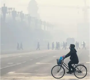  ?? WANG ZHAO/AFP/ GETTY IMAGES FILES ?? China’s ‘unbelievab­le smog crisis,’ fuelled by its incredible economic growth, has served as a wakeup call within China, prompting its Communist government to initiate more environmen­tal measures faster than many western nations. But scholars are debating whether China’s authoritar­ian system works for or against becoming an ‘ecological civilizati­on.’