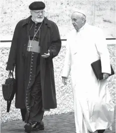  ?? ASSOCIATED PRESS ?? Pope Francis talks with the head of a sex abuse advisory commission, Cardinal Sean Patrick O'Malley, of Boston, as they arrive for a special consistory in the Synod hall at the Vatican.