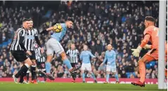  ??  ?? GETTY IMAGES Manchester City’s Sergio Aguero (3rd L) scores the first goal of his hat-trick in the 3-1 beating of Newcastle at the Etihad Stadium on January 20, 2018.