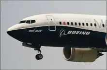  ?? ELAINE THOMPSON — THE ASSOCIATED PRESS ?? A Boeing 737Max jet, piloted by Federal Aviation Administra­tion Chief Steve Dickson in September, prepares to land at Boeing Field following a test flight in Seattle.