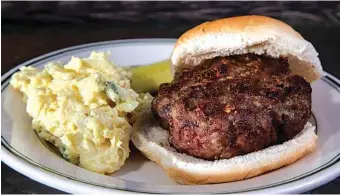  ?? PHOTOS BY COLTER PETERSON/ST. LOUIS POST-DISPATCH/TNS ?? The secret to this cheeseburg­er is to add grated cheese into the raw meat so that the cheese melts as the meat cooks.