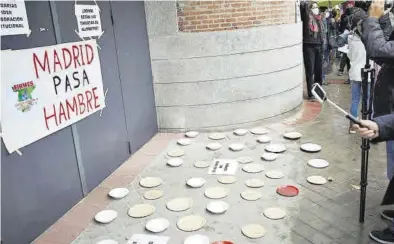  ?? EUROPA PRESS / JESÚS HELLÍN ?? Platos vacíos en el suelo frente a la puerta del Área de Familias, Igualdad y Bienestar Social, como signo de protesta.