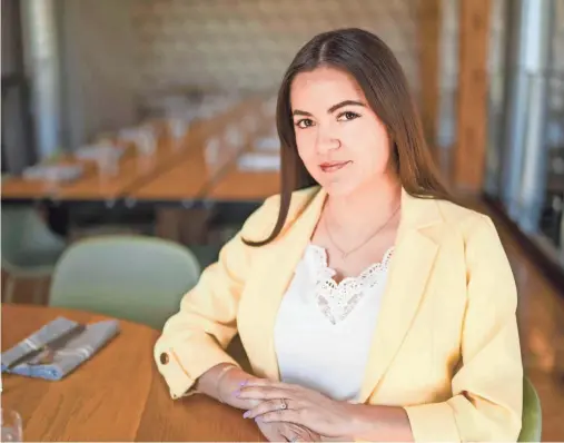  ?? ZACH BOYDEN-HOLMES/THE REGISTER ?? Tatiana Peña, owner and creator of Iowa Lovers on Tiktok, Instagram, and Facebook sits for a photo at St. Kilda Cafe & Bakery on April 12 in Des Moines.