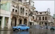  ?? THE ASSOCIATED PRESS ?? Traffic moves beside a building in need of repair, on the Malecon in Old Havana, Cuba, Tuesday, June 2, 2015. In some destinatio­ns, tourist areas are located far from the rhythms of everyday life. But visitors who wander through Old Havana or Habana...