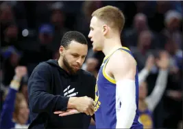  ?? RAY CHAVEZ — BAY AREA NEWS GROUP ?? Golden State Warriors guard Stephen Curry talks with Golden State Warriors guard Donte Divincenzo (0) after he scored a three-point basket in the second half of their NBA game against the Portland Trail Blazers at Chase Center in San Francisco on Feb. 28.