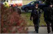  ?? BEN ALLAN SMITH — ANN ARBOR NEWS VIA AP ?? Washtenaw County sheriff’s deputies investigat­e a bomb threat in Scio Township, Michigan, on Thursday.